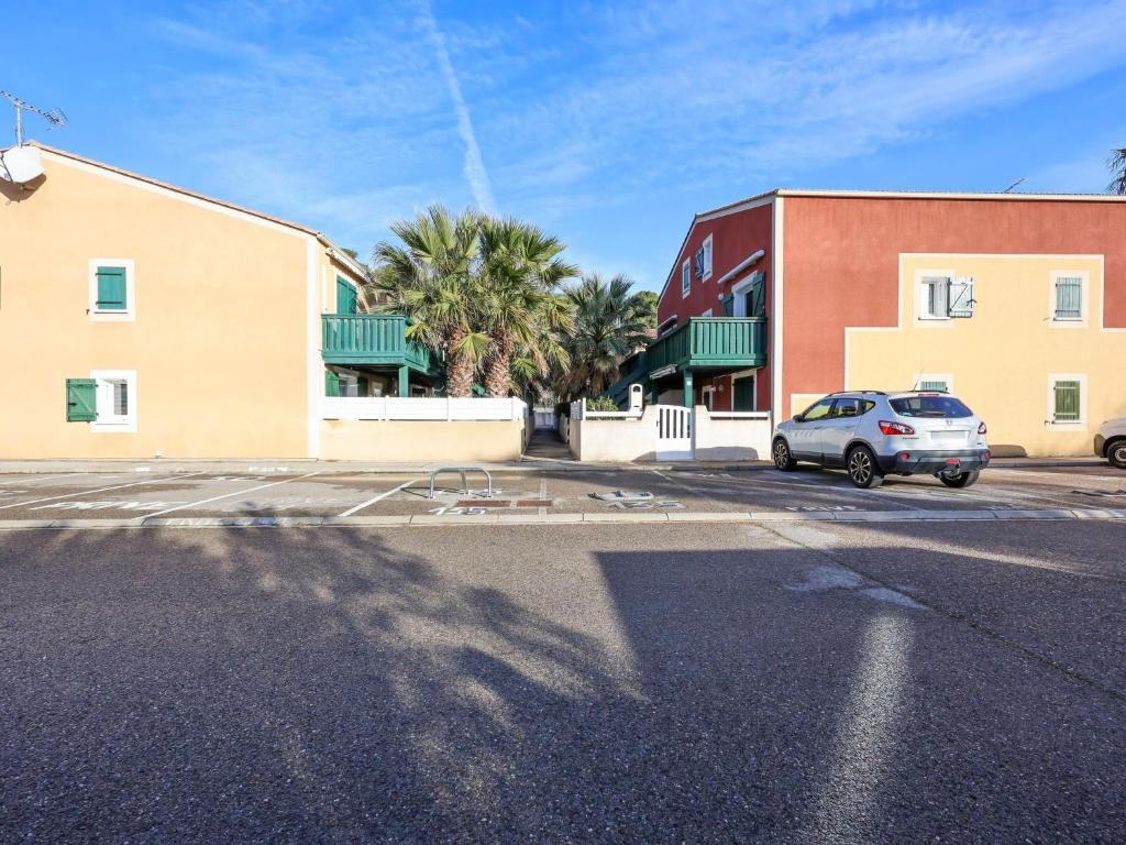 a car parked in a parking lot next to a building at Apartment Eden Roc 2 by Interhome in Narbonne-Plage