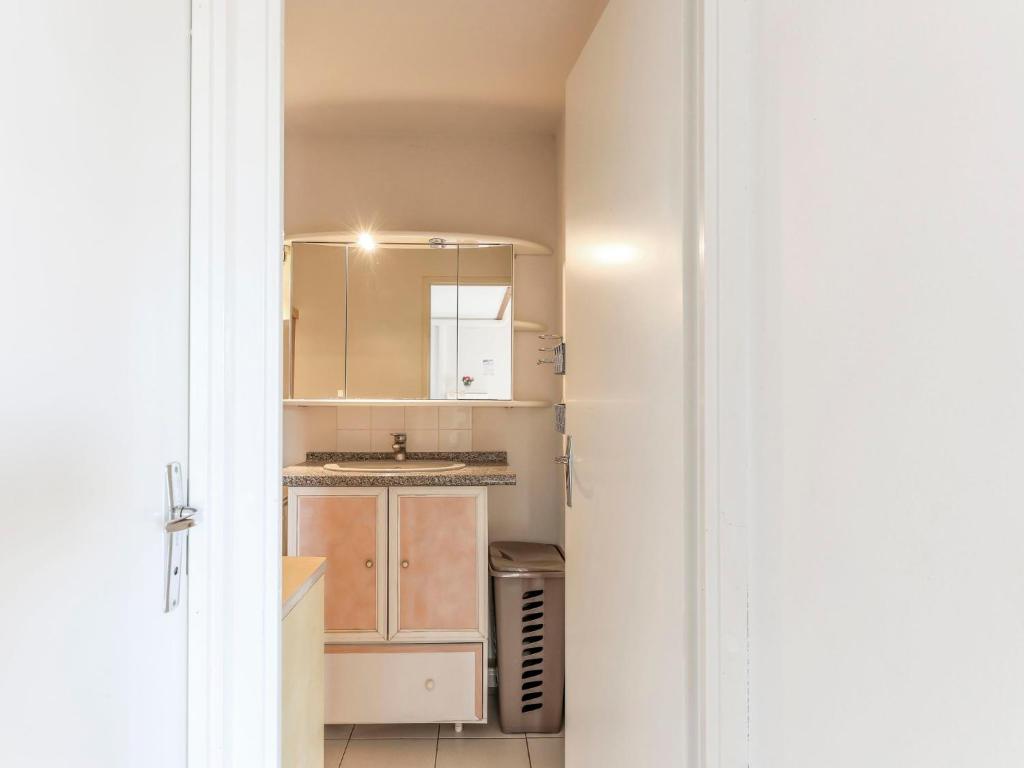 a kitchen with white cabinets and a sink at Apartment Eden Roc 2 by Interhome in Narbonne-Plage