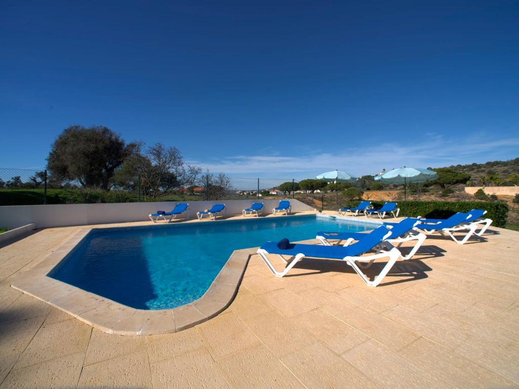 a swimming pool with lounge chairs and a swimming pool at Villa Mariana by Interhome in Galé