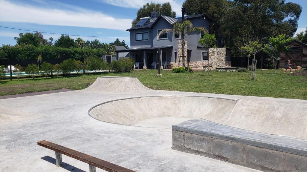 a skate park with a skateboard ramp in front of a house at MARESIA Surf House in Chapadmalal