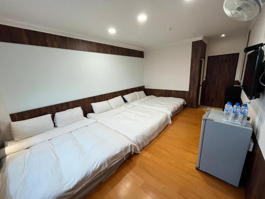 a room with a large bed with white sheets at Dongshan River Resort Farm in Wujie