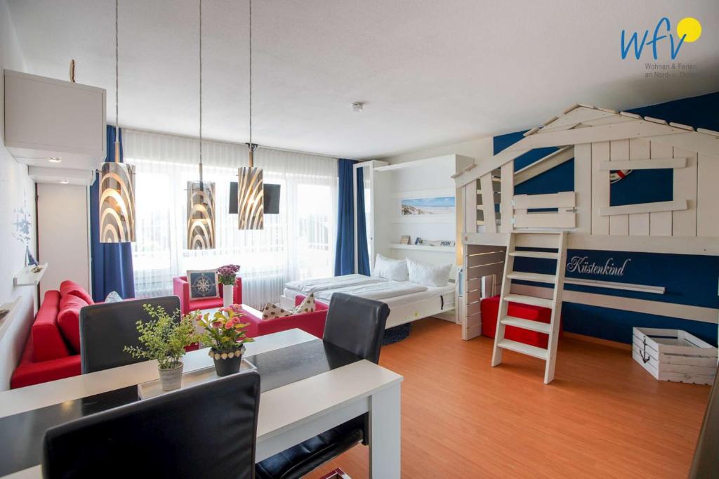 a living room with a bedroom with a bunk bed at Holiday Residenz - Ferienwohnung "Kuestenkind" in Borkum
