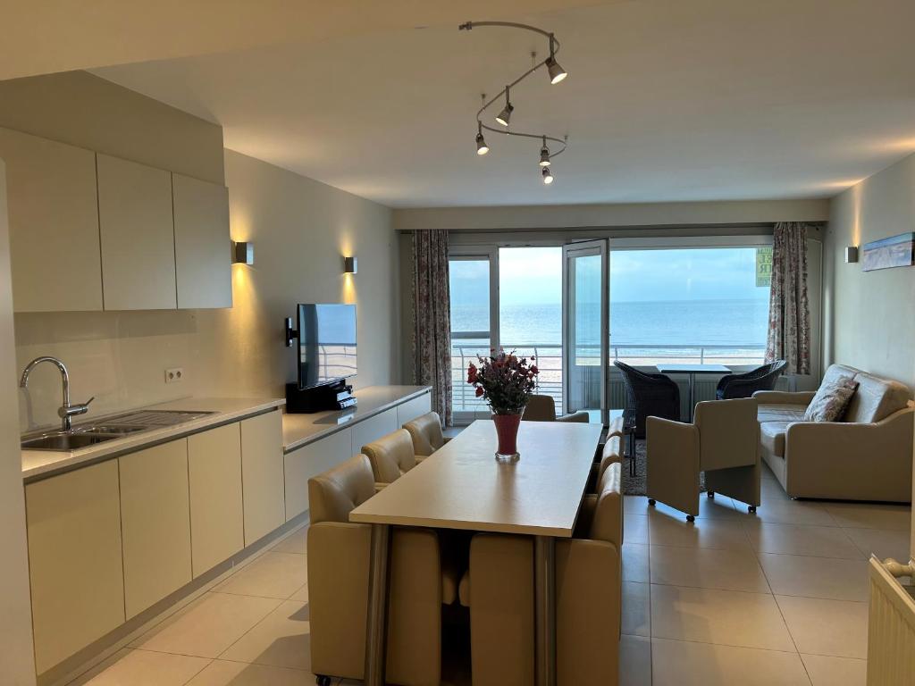 a kitchen and living room with a view of the ocean at "Puerto Cristo" - Great 2 Bedroom Appartment with Seaview D2 in Ostend