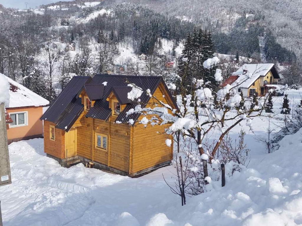 a wooden cabin with snow on the ground at Dušan_guest_house in Kolašin