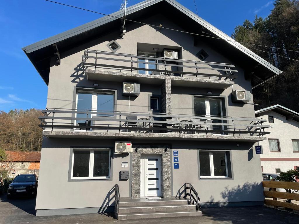 a house with a balcony on top of it at Apartmani "Stari Grad - Samobor" in Samobor