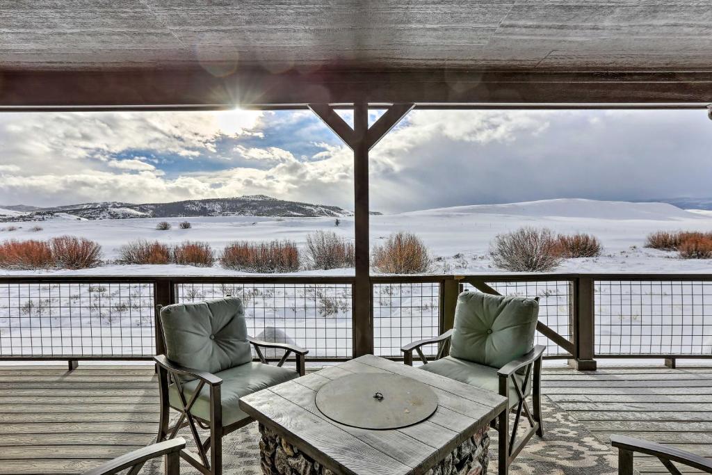 um alpendre com uma mesa e cadeiras e vista para um lago em Granby Golf Retreat with Ski Trails, Mountain View! em Granby