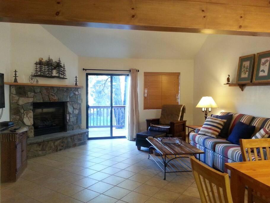a living room with a couch and a fireplace at Cozy Flagstaff Home in Cool Pines - Country Club in Flagstaff