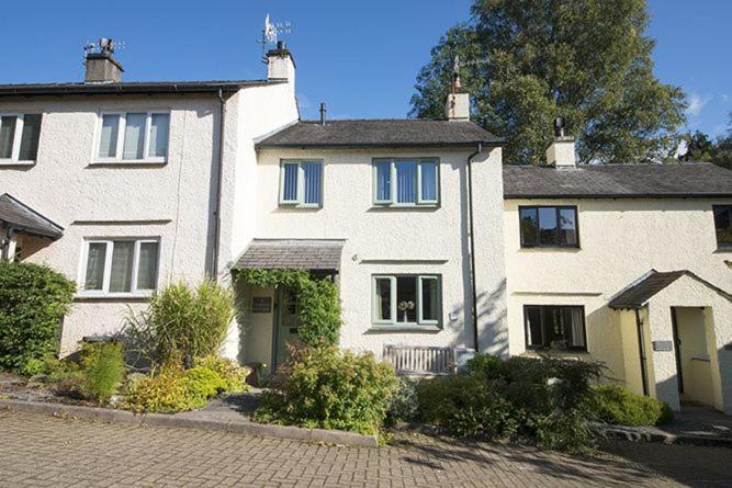 a large white house sitting on a street at Yewdale Cottage Coniston in Coniston