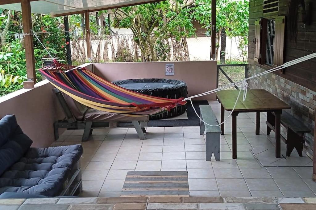a hammock on a patio with a fire pit at MO TI KOTÉ in Cayenne