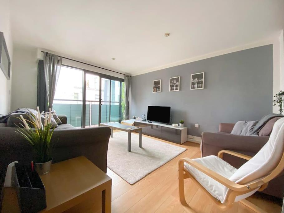 a living room with a couch and a tv at Beautifully Presented 2 Bedroom Apartment in Liverpool