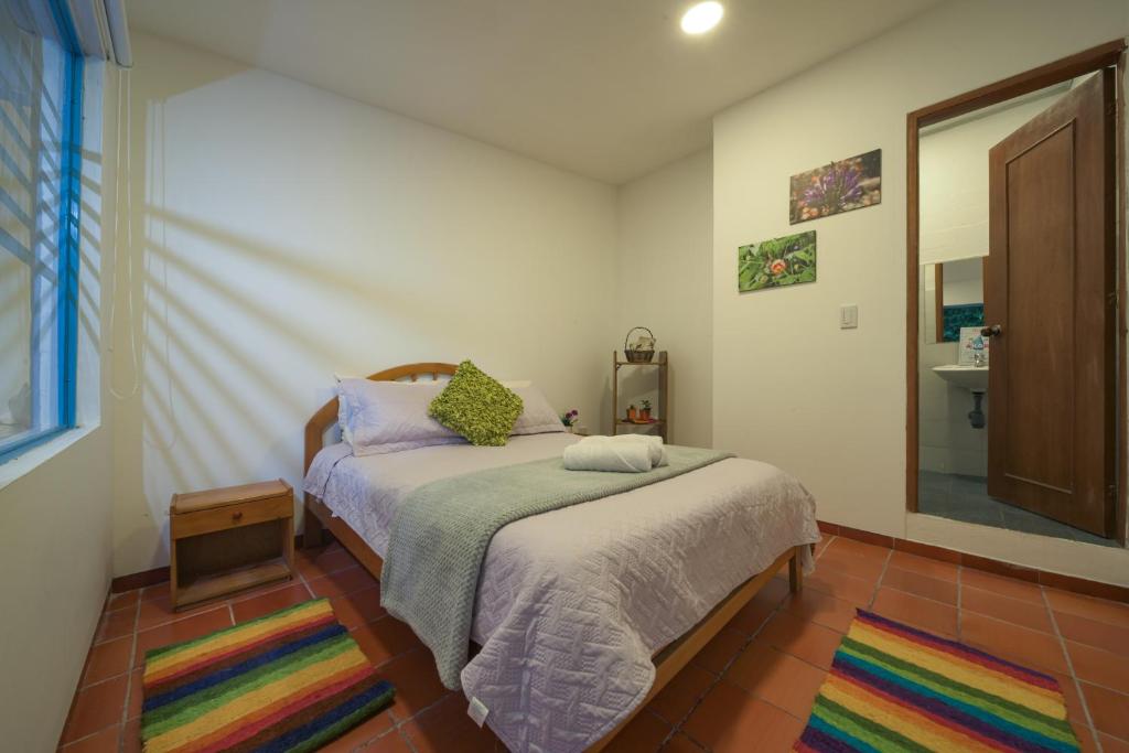 Кровать или кровати в номере Posada ecoturística Rogitama