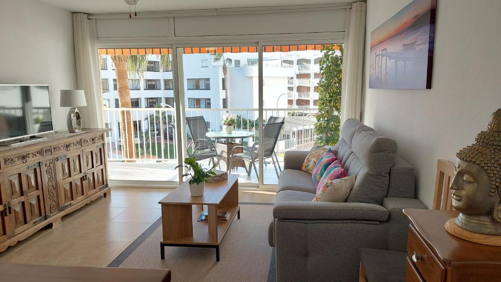 a living room with a couch and a table at BELLAMAR 25 in Cambrils