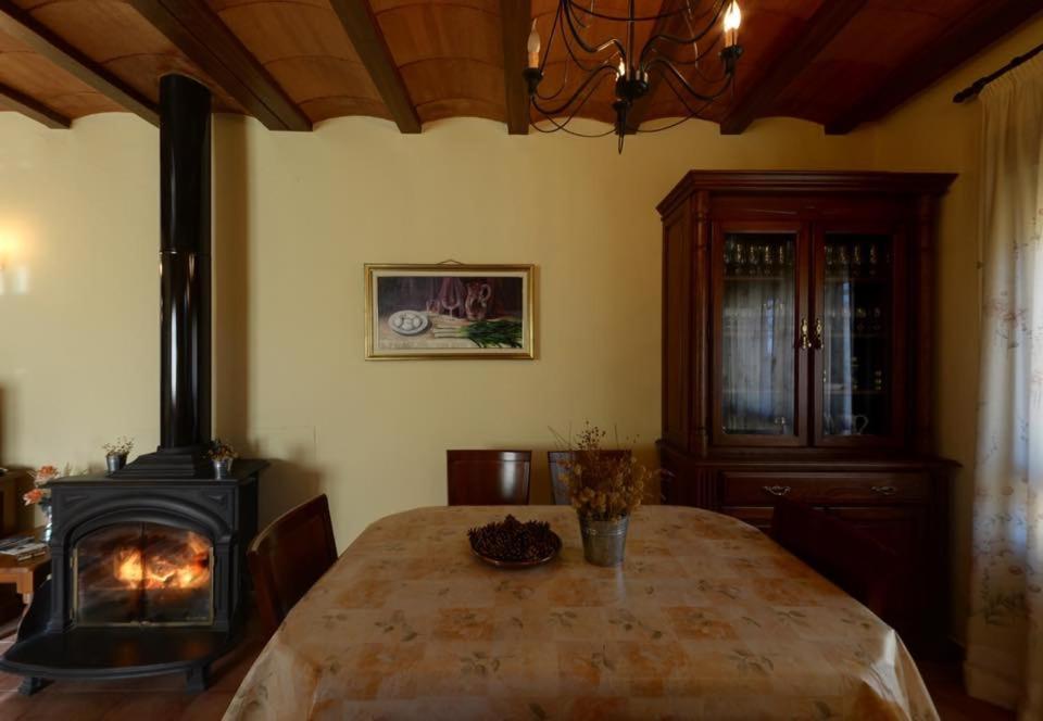 a dining room with a table and a stove at Las Tejas in Bayubas de Abajo