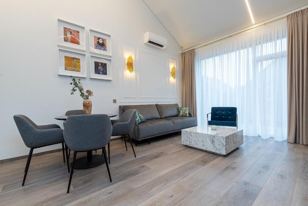 a living room with a couch and a table at Amber Stone Apartment 2nd floor in Palanga