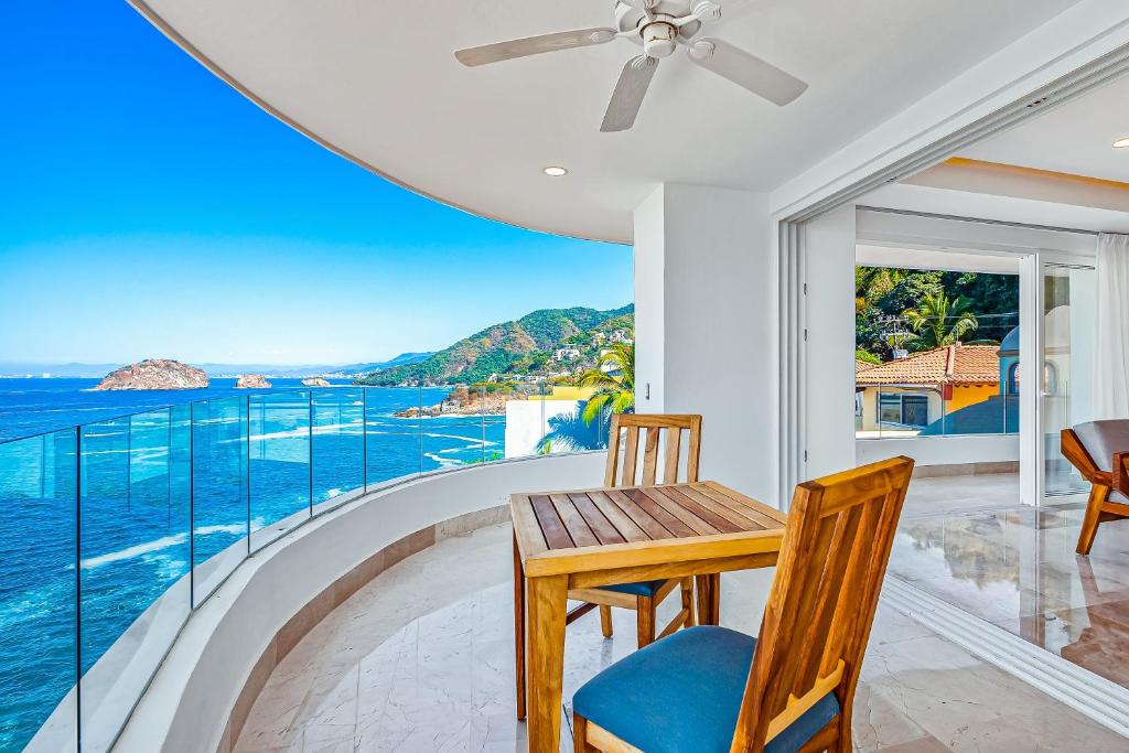 a dining room with a view of the ocean at Blue Horizon 701 in Puerto Vallarta
