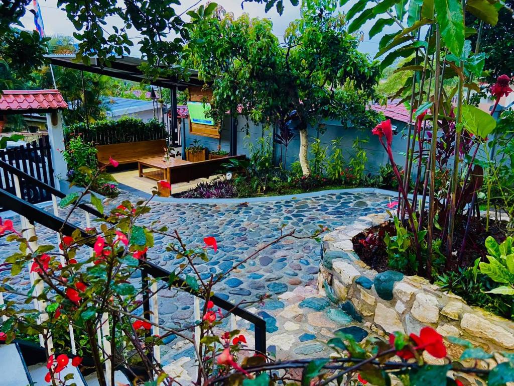 un jardín con una pasarela de piedra frente a una casa en Casa Los Madriz Suite #2, en San Isidro