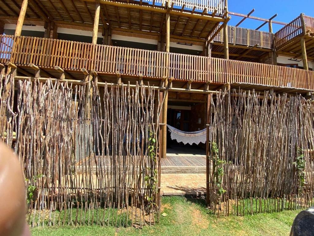 a building with a bunch of bamboo structures at Kaha Mar - Patacho in Pôrto de Pedras