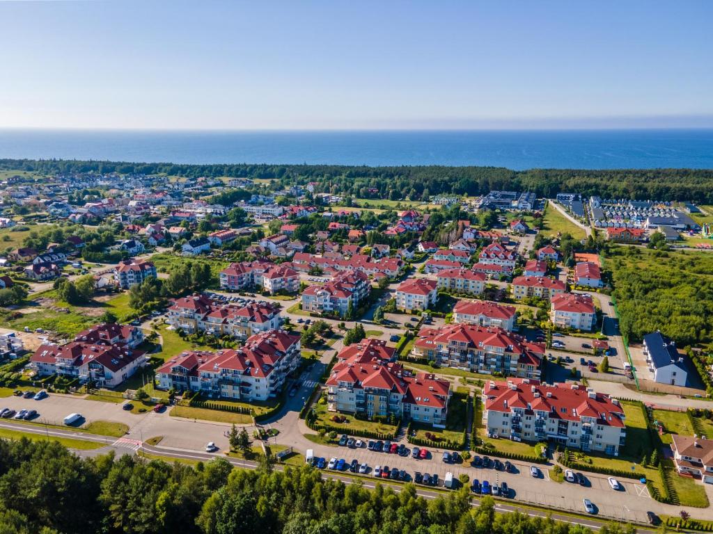 an aerial view of a residential neighbourhood with red roofs at Apartament na prywatnym Osiedlu! in Grzybowo