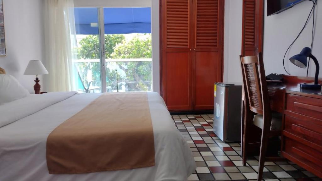 Postel nebo postele na pokoji v ubytování Hotel Bahia Cartagena