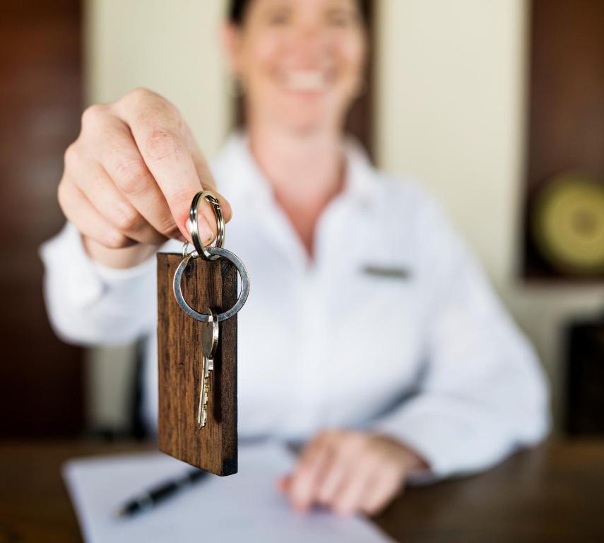 a person holding a key in their hand at EVN Boutique Hotel in Yerevan