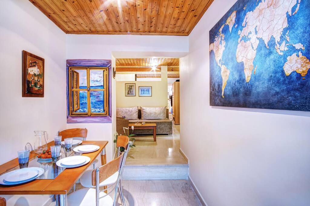 a dining room with a table and a map on the wall at Vavilato Home Kouramades in Kouramádes