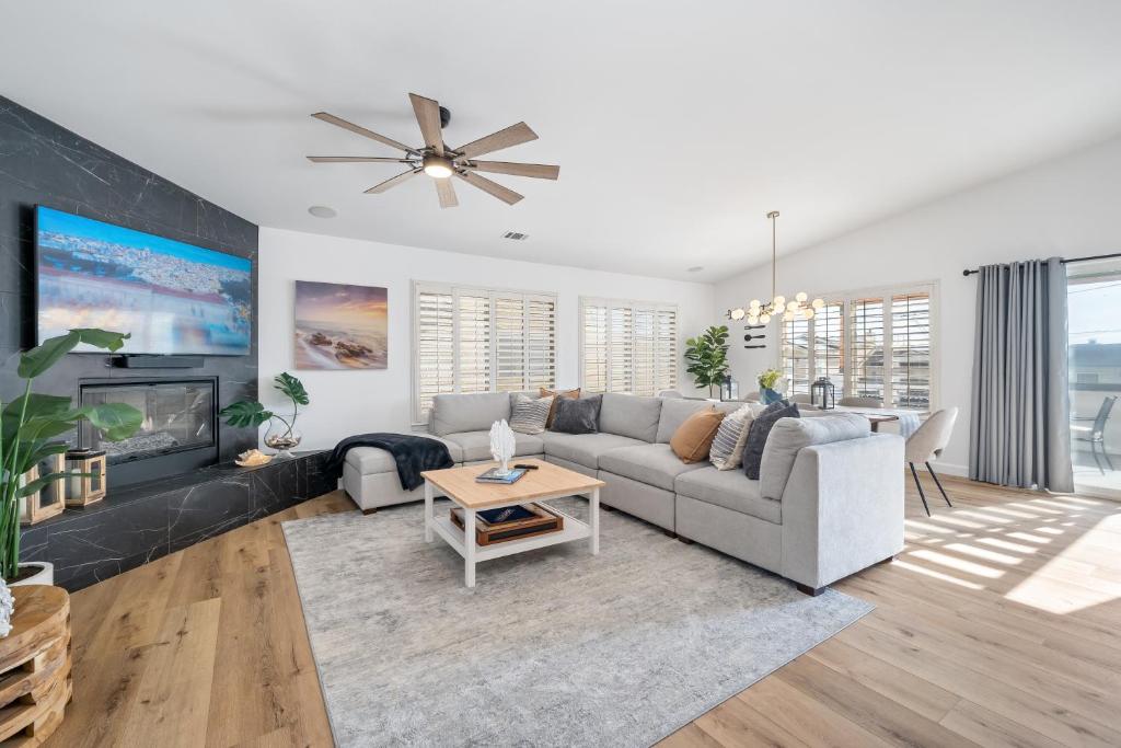 a living room with a couch and a fireplace at Steps To #PismoBeach with Poker, Foosball, FREE EV Charger, and Bikes in Oceano