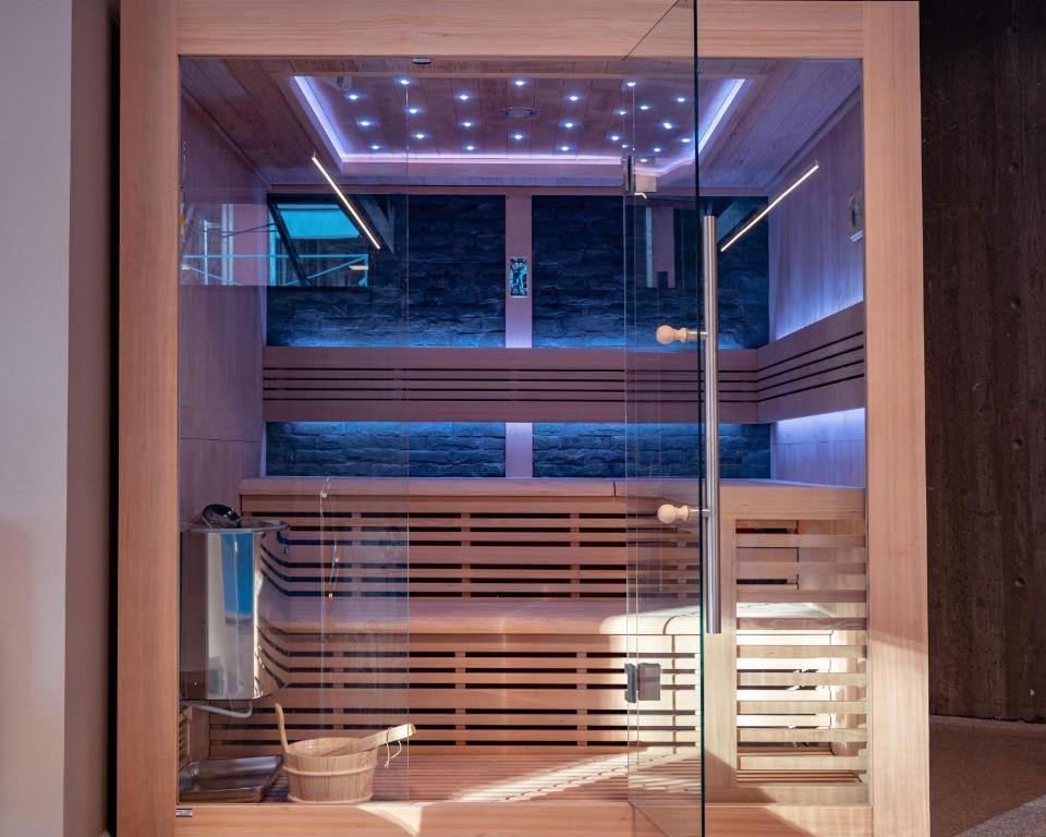 a glass door in a room with a bench behind it at Hytte på sørlandet in Kristiansand