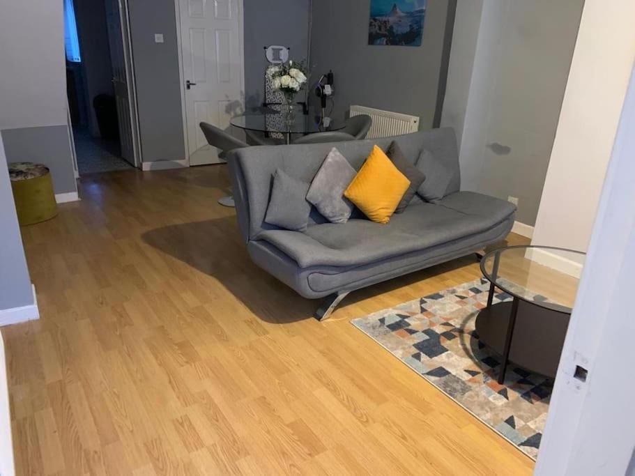 a living room with a couch and a table at Goodison Lodge in Liverpool