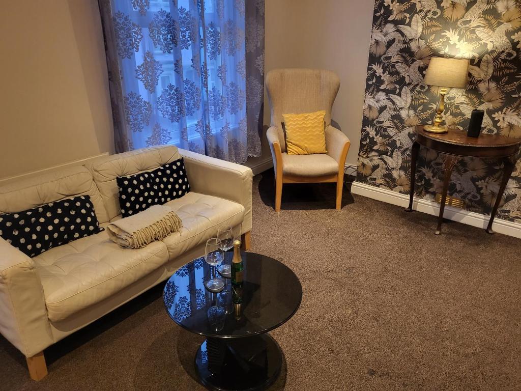 a living room with a couch and two chairs and a table at Exclusive apartment in Bristol in Bristol