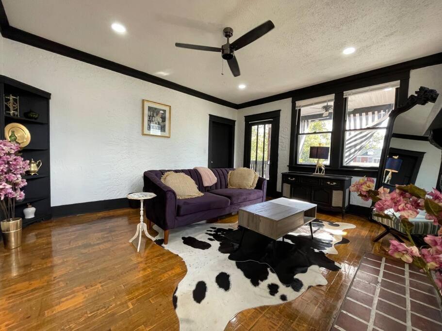 a living room with a couch and a cow rug at Midtown Casablanca in Memphis