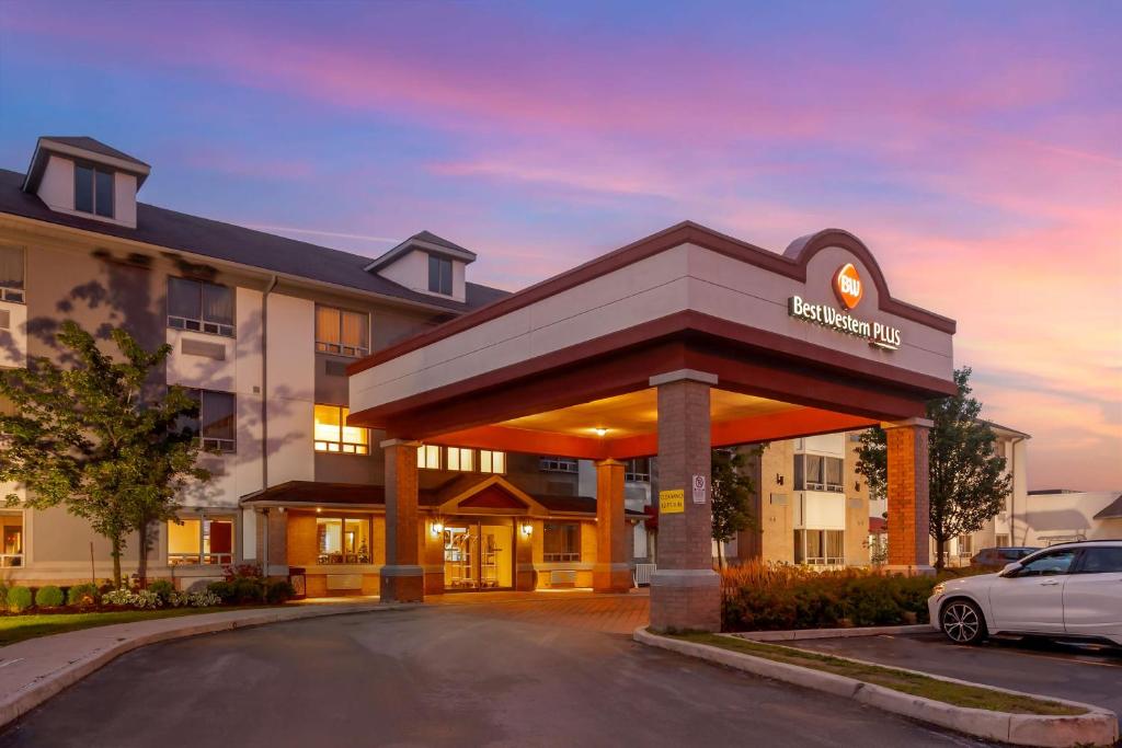 a hotel with a car parked in front of it at Best Western Plus Burlington Inn & Suites in Burlington