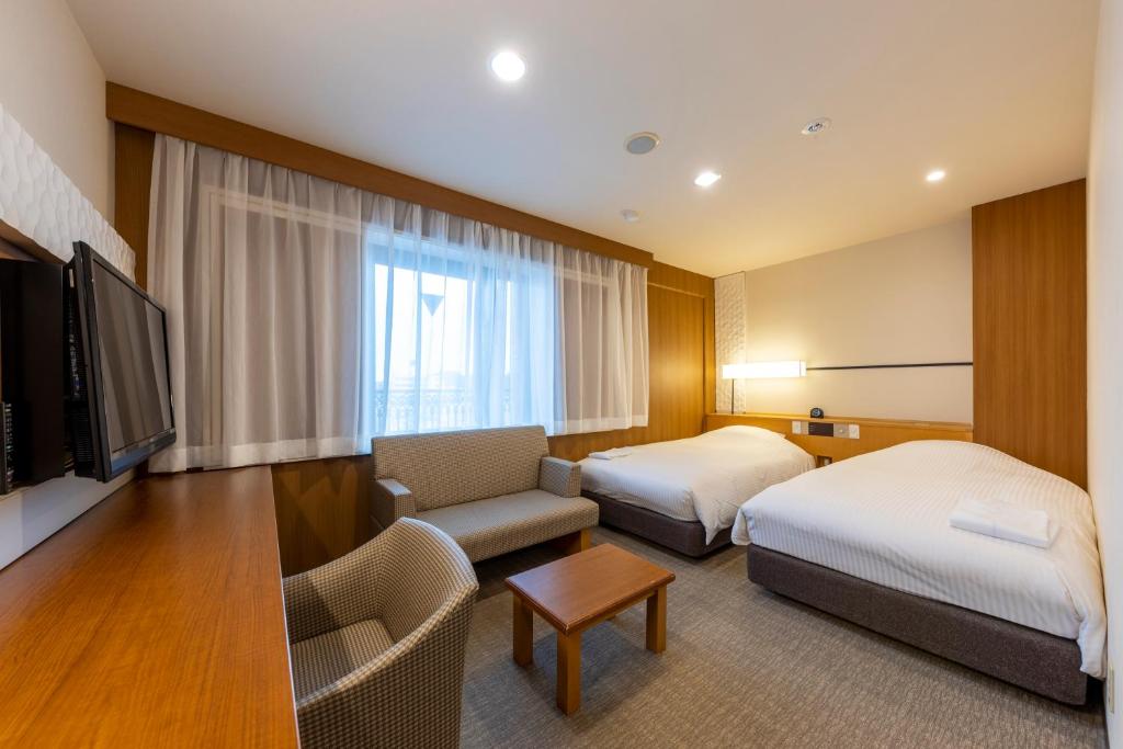 Postel nebo postele na pokoji v ubytování JR CLEMENT INN HIMEJI