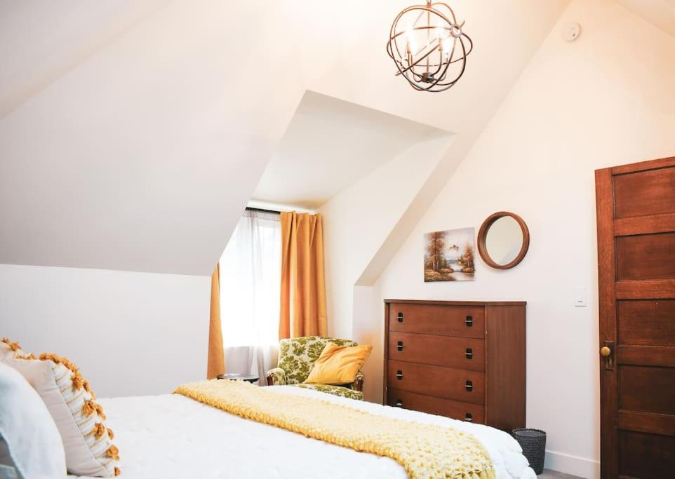 ein Schlafzimmer mit einem Bett, einer Kommode und einem Stuhl in der Unterkunft The BARN - Washington Park, Private Guesthouse in Denver