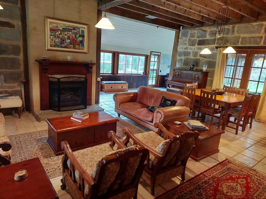 a living room with a couch and a fireplace at The Stone House Stay Connect Explore in Pokolbin