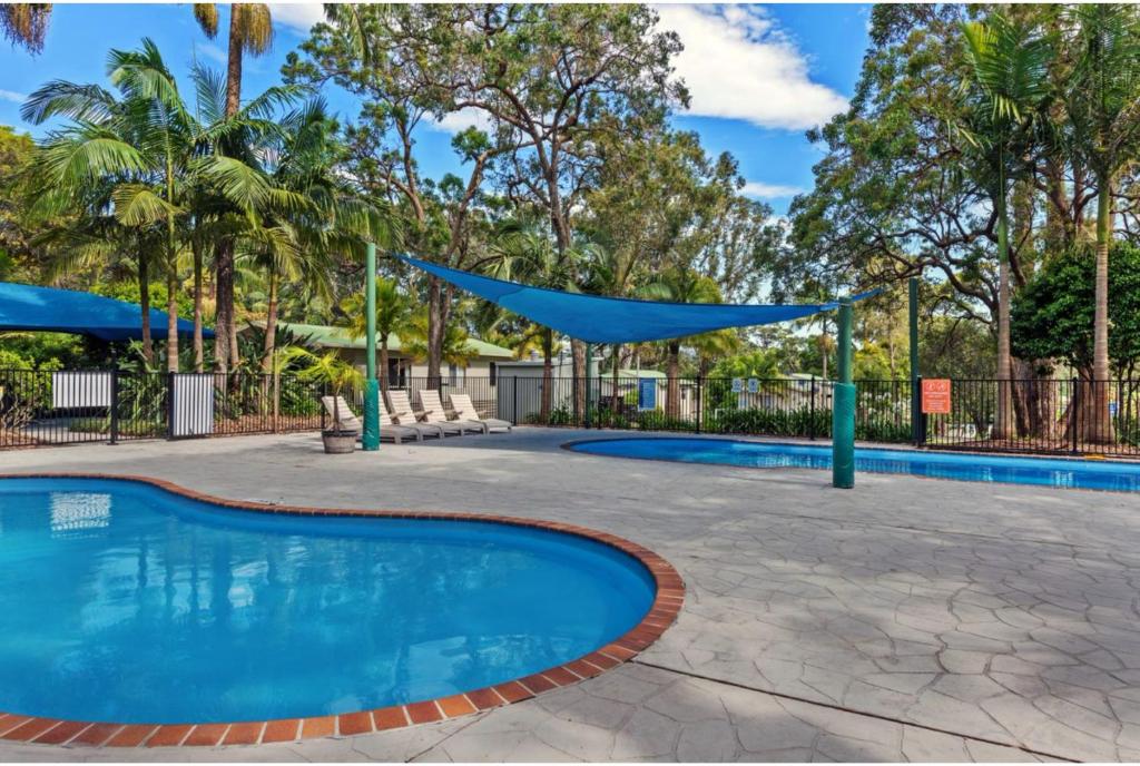 a swimming pool with a blue tarp over it at Discovery Parks - Burrill Lake, Ulladulla in Burrill Lake