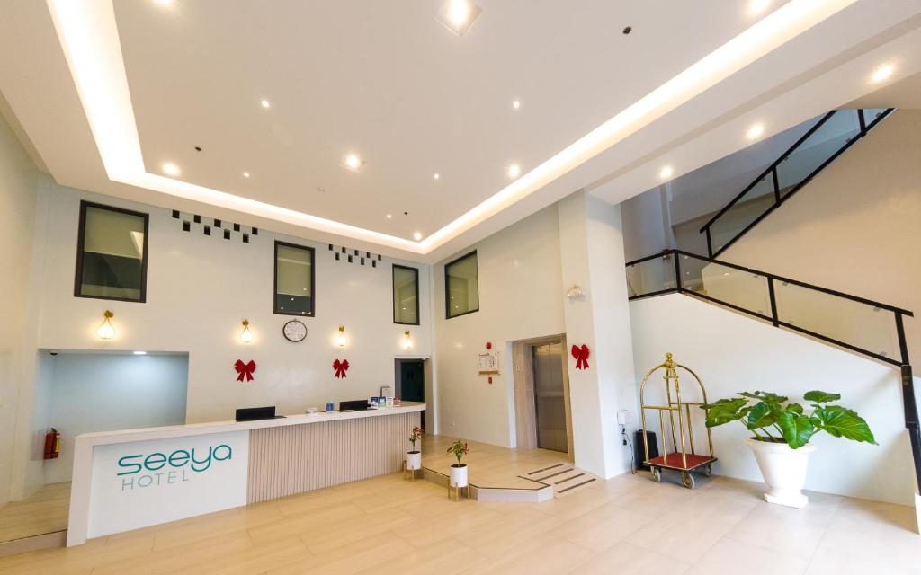 an office lobby with a reception desk and a staircase at Seeya Hotel in Tubigon