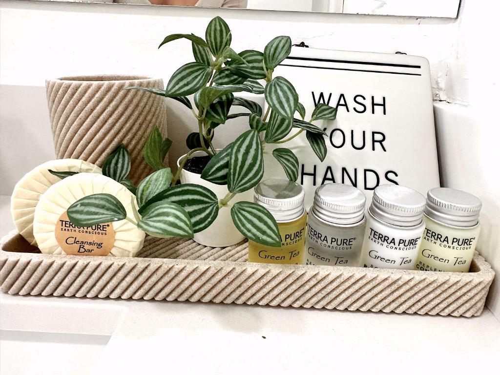 a basket with a plant and a sign that reads wash our hands at NEW Comfy and Modern House near Miami Airport in Miami