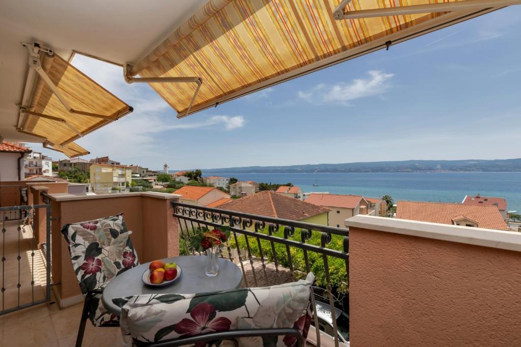 a balcony with a table with a bowl of fruit on it at Room 79-3 in Duće