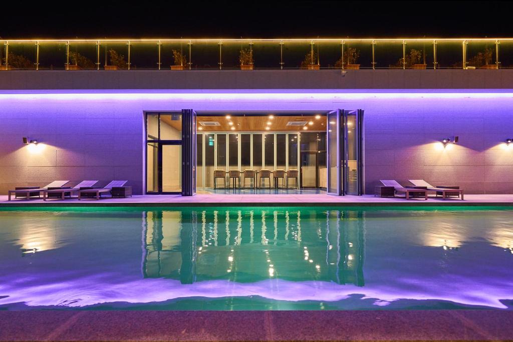 a swimming pool in a building at night at JN PARK Hotel in Incheon