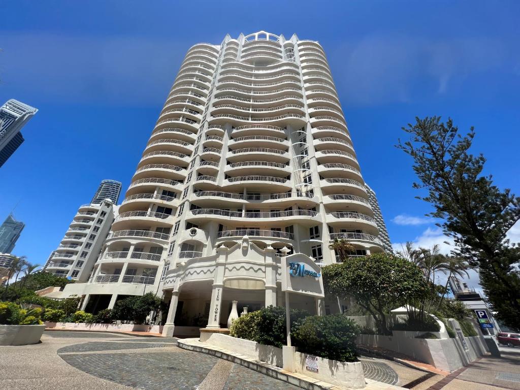 a tall white building in front of a blue sky at Stunning 2 bedroom Ocean View Apartment in Gold Coast