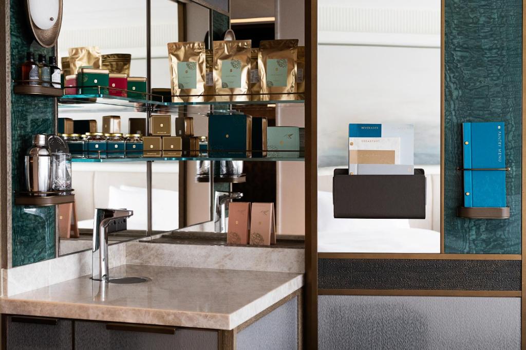 a kitchen with a counter and a shelf with boxes at Island Shangri-La, Hong Kong in Hong Kong