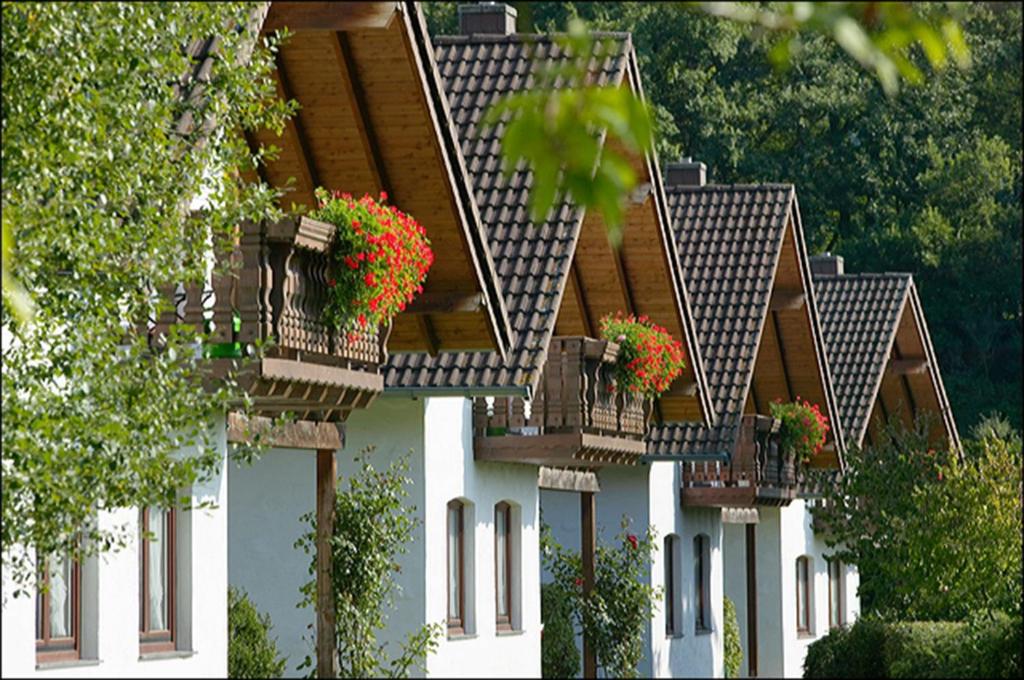 a white building with flower boxes on it at Ferienpark Rursee in Simmerath