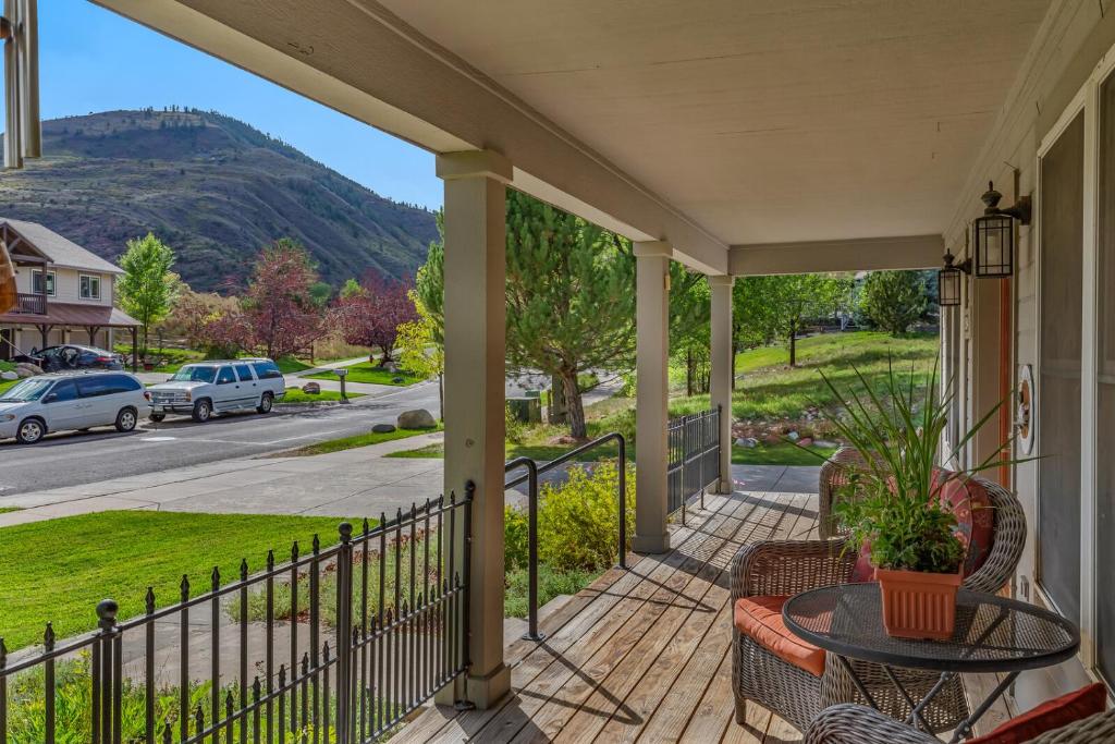 a porch with a table and chairs and a view of a street at Cozy Home with Sauna in Glenwood Springs in Glenwood Springs