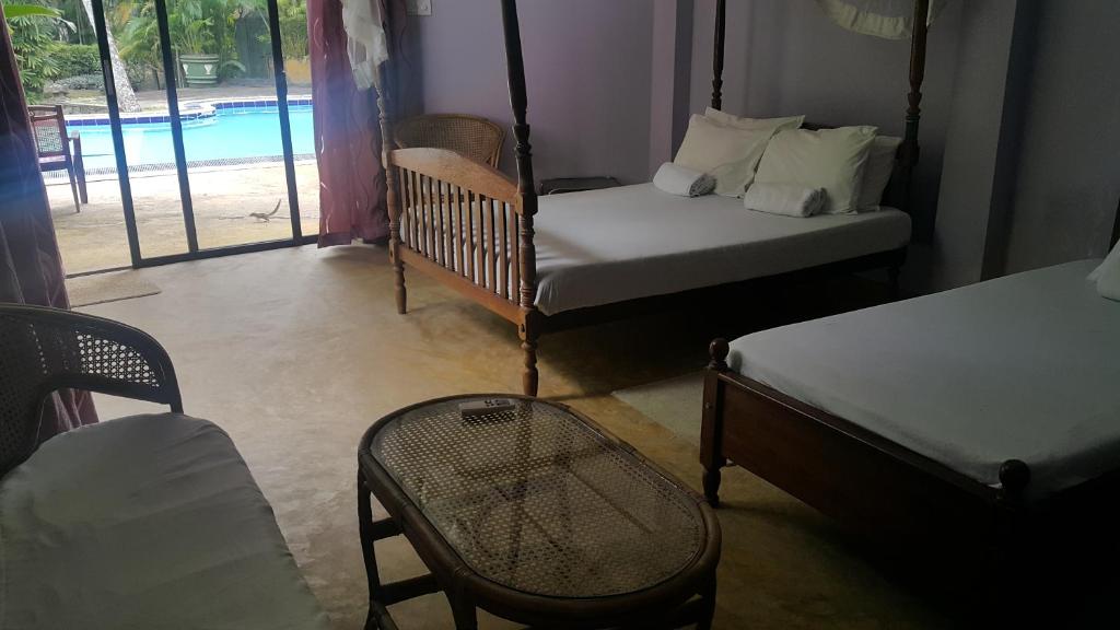 Postel nebo postele na pokoji v ubytování Leijay Garden Retreat