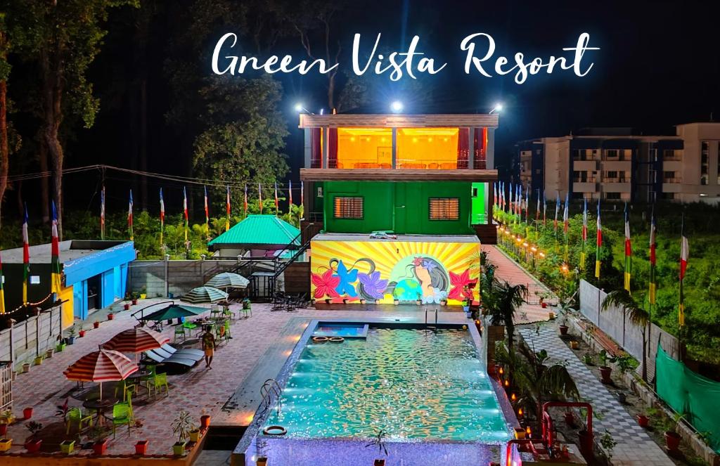 a resort with a swimming pool at night at Green Vista Resort in Chālsa