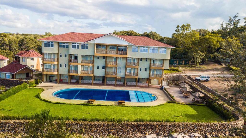 an aerial view of a large house with a swimming pool at KISIMANI ECO RESORT & SPA LTD in Isiolo