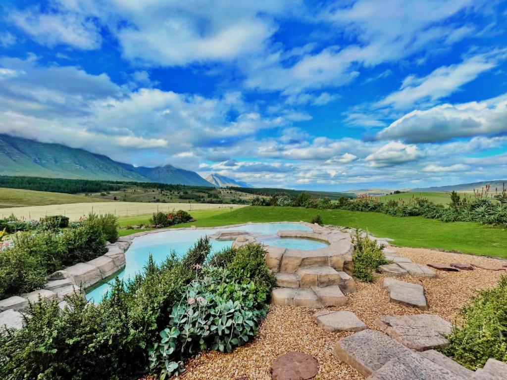 an aerial view of a backyard with a swimming pool and a stone walkway at Oudebosch Guest Farm in Riversdale