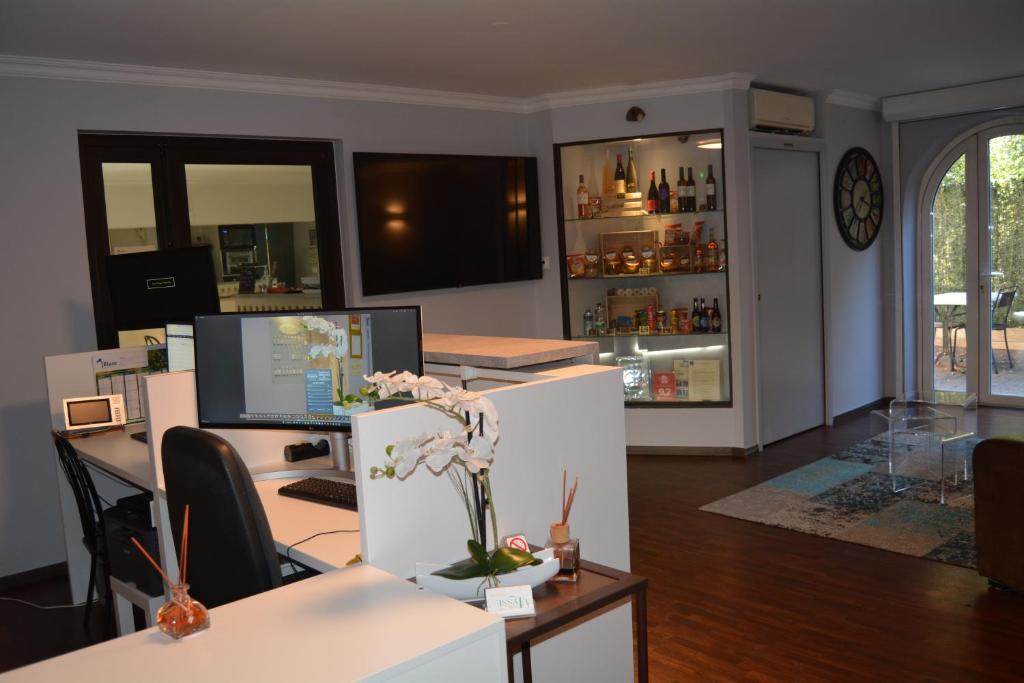 an office with a desk with a computer on it at Hôtel Ulysse Montpellier Centre in Montpellier