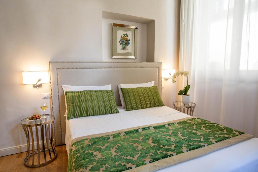 Postel nebo postele na pokoji v ubytování Boutique Hotel del Corso