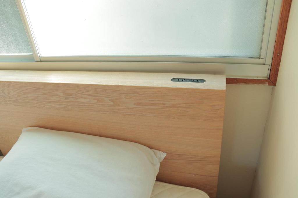 Postel nebo postele na pokoji v ubytování KUMANOYASAI BASE in Chikatsuyu